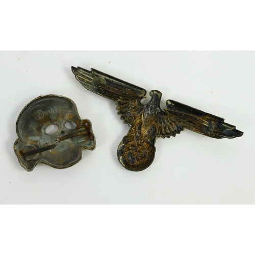 1352 - A Third Reich period pressed metal Totenkopf, stamped RMZ M1/17, together with a cap badge.