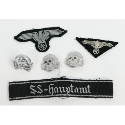 1353 - An SS armband SS-Hauptamt (SS-Main Office), two cloth badges, two totenkopf pressed metal badges, be... 