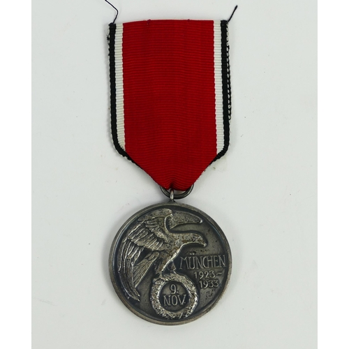 1354 - A Third Reich period Blood Order Medal, numbered 677, with ribbon,