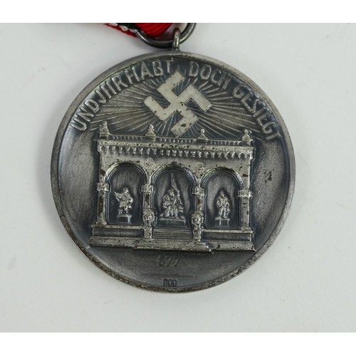 1354 - A Third Reich period Blood Order Medal, numbered 677, with ribbon,