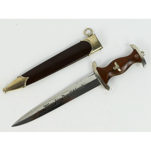 1365 - A Third Reich period SA dagger, with 22cm bladed etched with motto and RZM M7/33, having a wood grip... 