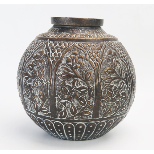 1378 - An Indian embossed copper jardiniere of ovoid form with panels of trailing plants, 20cm high.