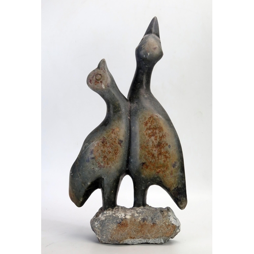 1382 - A carved soapstone figure group of two birds with their heads turned skywards, 40cm high.