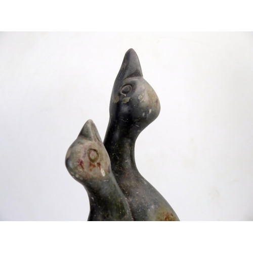 1382 - A carved soapstone figure group of two birds with their heads turned skywards, 40cm high.