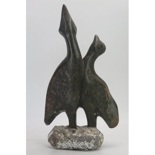 1382 - A carved soapstone figure group of two birds with their heads turned skywards, 40cm high.