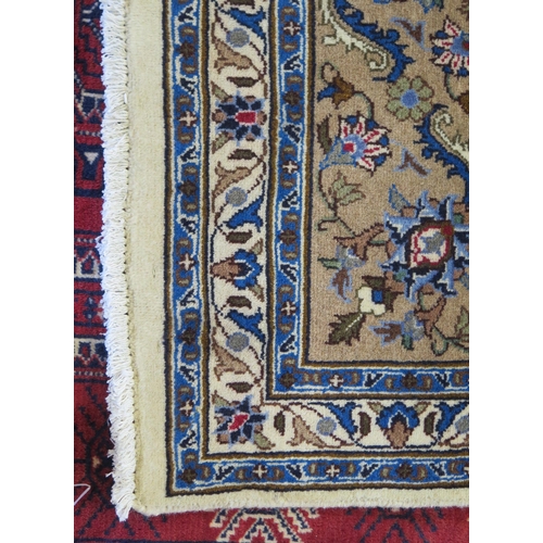 1393 - A Meshed rug, the ivory field with central circular floral medallion, with beige floral spandrels en... 