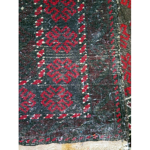 1396 - An Afghan baluch prayer rug, the wine red field with hooked and stepped mirab, enclosed by a triple ... 