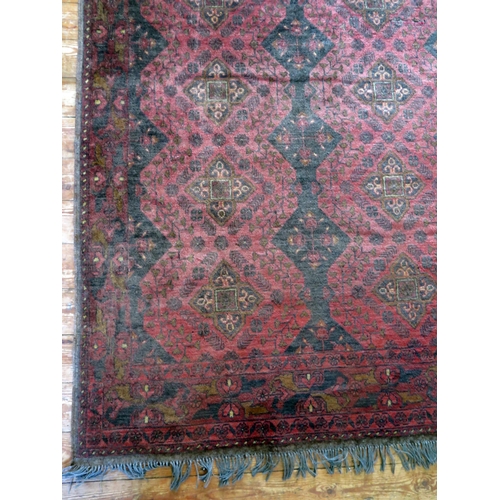 1401 - A Hamadan rug, the wine red field with two rows of lozenge medallions, enclosed by a floral meander ... 