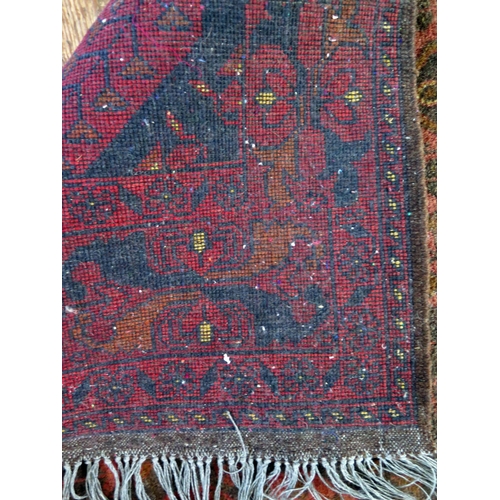 1401 - A Hamadan rug, the wine red field with two rows of lozenge medallions, enclosed by a floral meander ... 