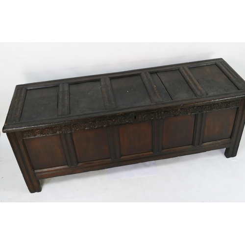 1415 - A 17th century  coffer of large size, with five panelled hinged lid and front with foliate frieze da... 