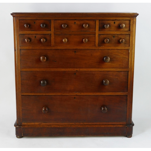 1417 - A Victorian mahogany chest containing an arrangement  of four short, one deep and three long drawers... 