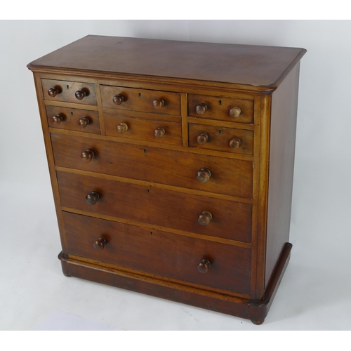 1417 - A Victorian mahogany chest containing an arrangement  of four short, one deep and three long drawers... 