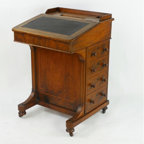 1428 - A Victorian mahogany and boxwood strung davenport, with sloping writing surface enclosing pigeon hol... 