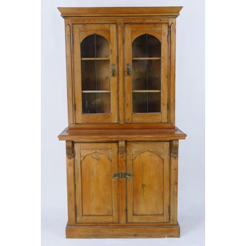 1431 - A Victorian pine dresser. the upper part with a pair of arched glazed panelled doors, the base conta... 