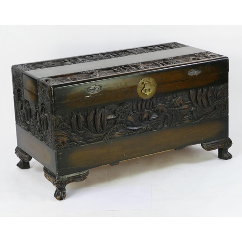 1435 - A Southeast Asian carved camphor wood chest of rectangular form, the hinged lid decorated with coast... 