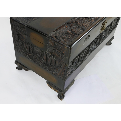 1435 - A Southeast Asian carved camphor wood chest of rectangular form, the hinged lid decorated with coast... 