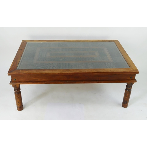 1439 - An Indian hardwood low occasional table of rectangular outline, the top with inset with carved wood ... 