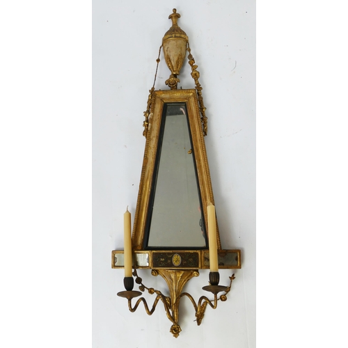 1446 - A continental gilt wood girandole, with tapering mirror plate surmounted by an urn, with twin scroll... 