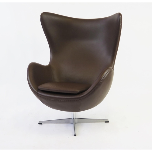 1452 - An Arne Jacobsen style, brown leatherette egg chair on chrome cruciform swivel base.