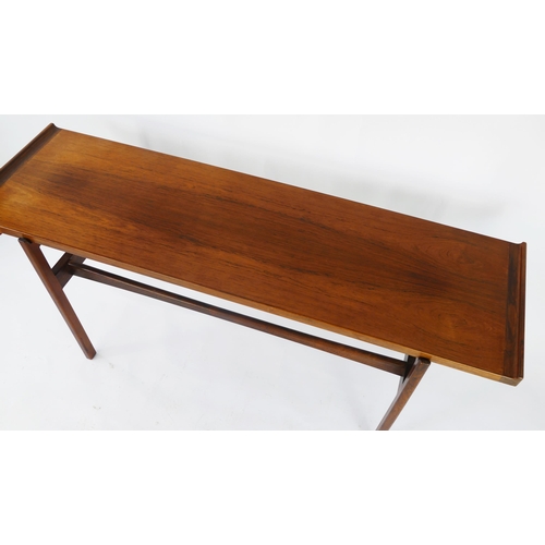 1465 - A Danish rosewood side table by Finn Juhl for Vodder, the rectangular top with swept ends, raised on... 