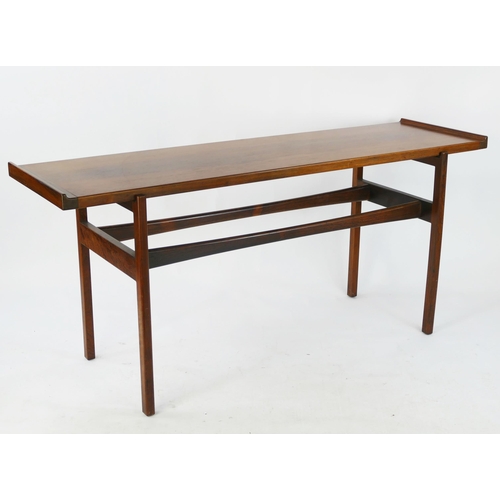 1465 - A Danish rosewood side table by Finn Juhl for Vodder, the rectangular top with swept ends, raised on... 