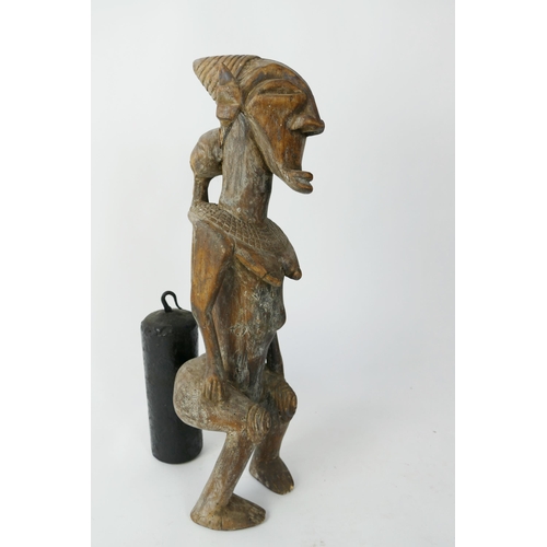 872 - An African Luba Carved Wooden Figure of an Elderly Female with mask to the back, 48cm