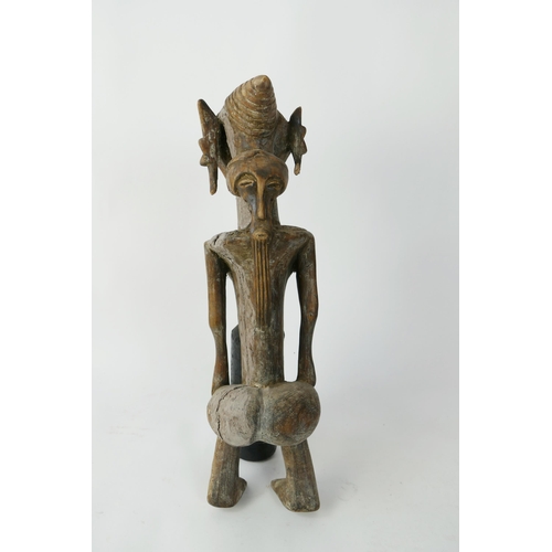 872 - An African Luba Carved Wooden Figure of an Elderly Female with mask to the back, 48cm