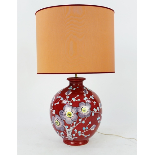 1071A - A large Italian pottery lamp, of ovoid form with floral decoration to a wine red field, with shade. ... 