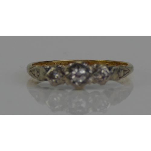 101 - An 18ct Gold and Diamond Three Stone Ring, c. 2.4mm principal brilliant round cut illusion set in pl... 