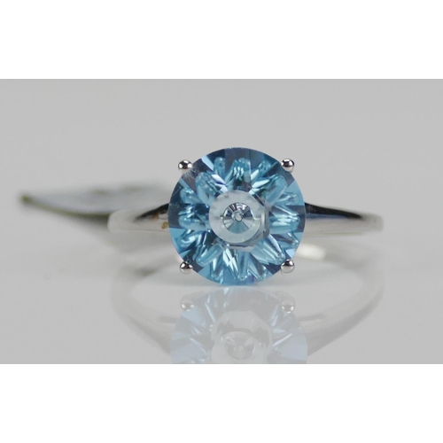 113 - A 10K White Gold and Blue Topaz Solitaire Ring, 10.15mm stone, size P.25, stamped 10K and 9ct gold h... 