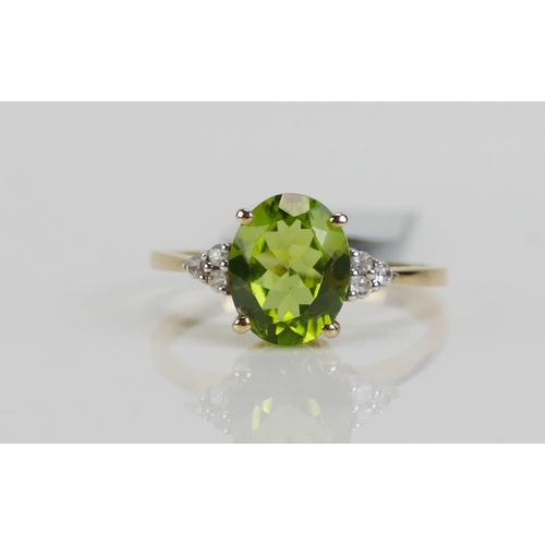 120 - A 10K Gold, Changbai Peridot and Zircon Ring, 10.1x8mm principal stone, size P, stamped 10K and 9ct ... 