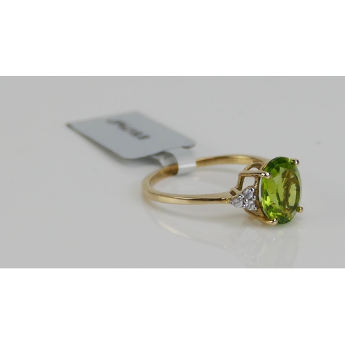 120 - A 10K Gold, Changbai Peridot and Zircon Ring, 10.1x8mm principal stone, size P, stamped 10K and 9ct ... 