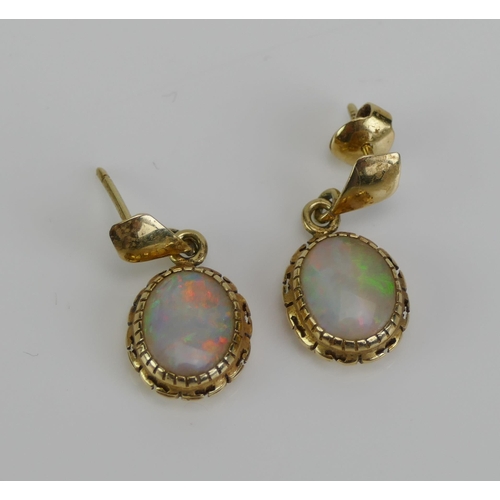 132 - A Pair of Opal Pendant Earrings in a precious yellow metal setting, 22.5mm drop, KEE tests as 14K, 2... 