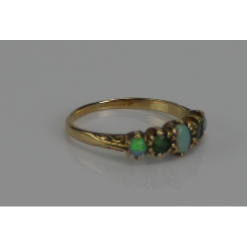 136 - An Opal and Gem Set Five Stone Ring in a precious yellow metal setting, marks dirty, KEE tests as 9c... 