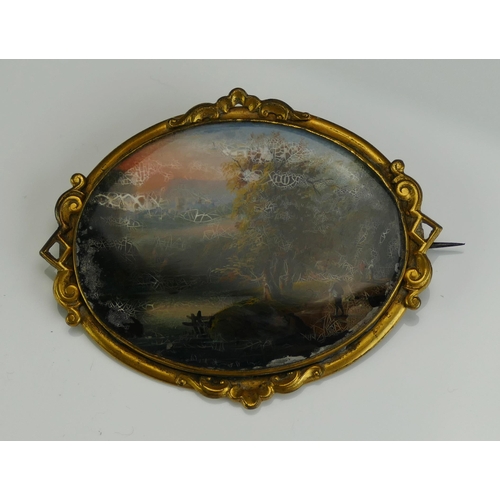 145 - A 19th Century Miniature Landscape Brooch in a gilt metal surround, painted on a copper panel, 62.9x... 