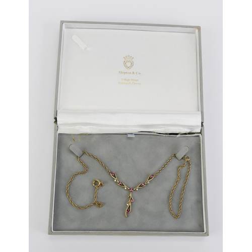 15 - A 9K Gold, Ruby and Diamond Necklace, 56mm wide central element, 30mm drop, stamped 375 9K, 7.73g