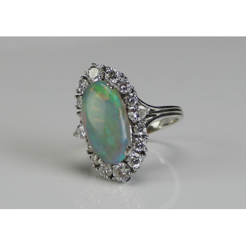 196 - An Opal and Diamond Oval Cluster Ring **ADJUSTMENT _ Undersold lots**