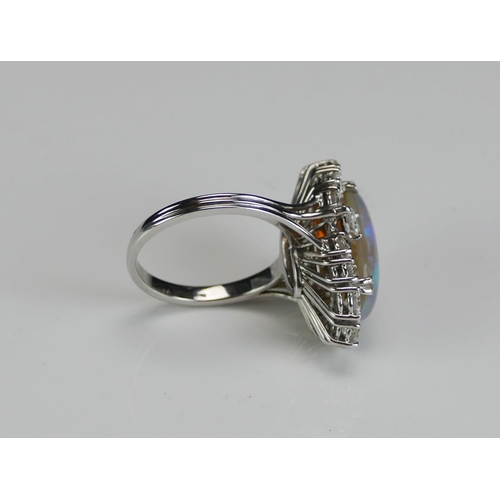 196 - An Opal and Diamond Oval Cluster Ring **ADJUSTMENT _ Undersold lots**