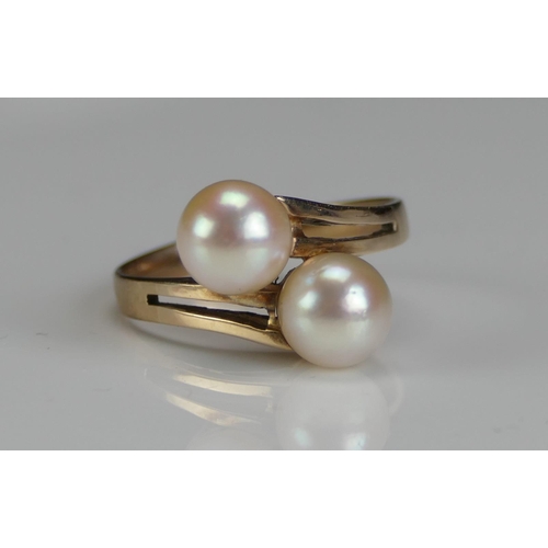 198 - A 9ct Gold and Twin Cultured Pearl Crossover Ring, c. 6.8mm, size L.5, stamped 9CT, 3.1g