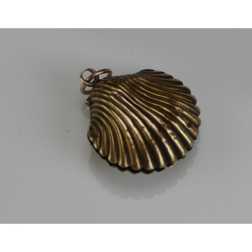 210 - An Antique Precious Yellow Metal Clam Shaped Memorial Locket containing a memento of platted hair, 2... 