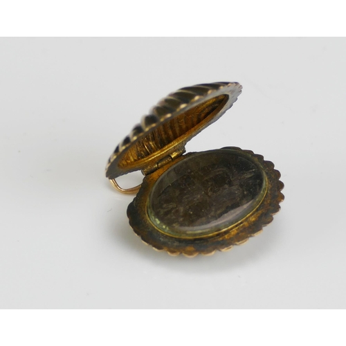 210 - An Antique Precious Yellow Metal Clam Shaped Memorial Locket containing a memento of platted hair, 2... 