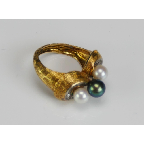 215 - A 1970's Pearl or Cultured Pearl and Diamond Ring in a high carat precious yellow metal setting a ce... 