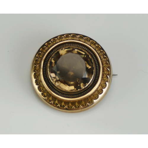 216 - An Antique Smoky Quartz Brooch in a precious yellow metal mount, 26.5mm diam., KEE tests as 15ct, 5.... 