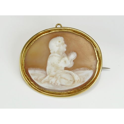 224 - A 19th Century Shell Cameo Brooch decorated with a kneeling figure in prayer and in a high carat pre... 