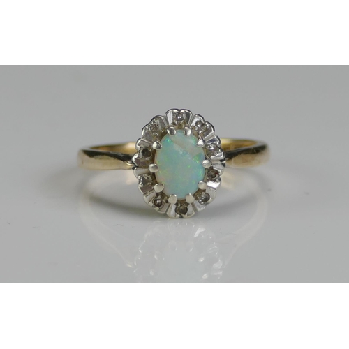 235 - A 9ct Gold, Opal and Diamond Cluster Ring, size L.75, hallmarked, 3g