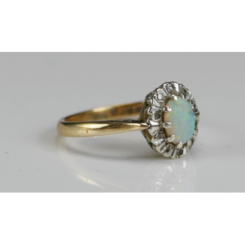 235 - A 9ct Gold, Opal and Diamond Cluster Ring, size L.75, hallmarked, 3g