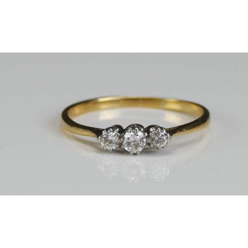 243 - An 18ct Gold and Diamond Three Stone Ring, 3.1mm principal platinum set stone, size S.5, stamped PLA... 