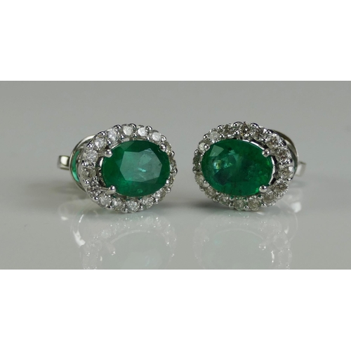 257 - A Pair of 18K White Gold, Emerald and Diamond Cluster Stud Earrings, 11.8x9.9mm head, stamped 18K, 4... 