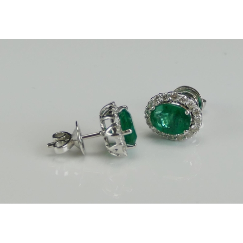 257 - A Pair of 18K White Gold, Emerald and Diamond Cluster Stud Earrings, 11.8x9.9mm head, stamped 18K, 4... 