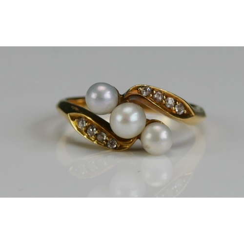 260 - A Cultured Pearl and Diamond Crossover Ring in a high carat precious yellow metal setting, 4.4mm lar... 